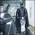 Adi posing beside Batman