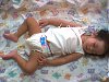 Baby sleeping on top of quilt